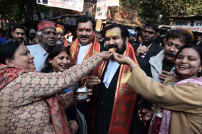 Hindu devotees offer sweets to lawyer Vishnu Shankar Jain after Varanasi district court ruled they be allowed to pray in the cellar of the Gyanvapi Mosque. EPA