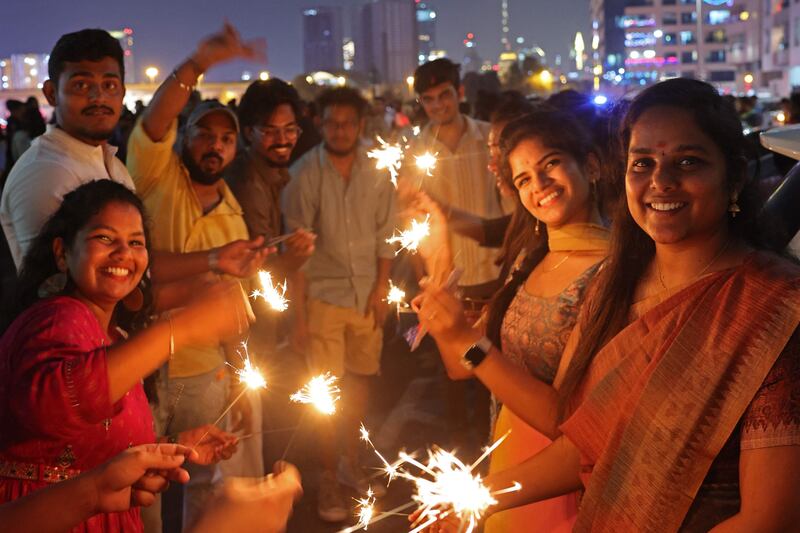 Indians light firecrackers as they celebrate Diwali in Dubai's Bur Dubai district. AFP