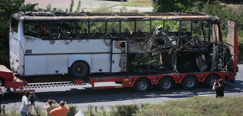 FILE - In this Thursday, July 19, 2012 file photo, a damaged bus is transported out of Burgas airport, Bulgaria, a day after a deadly suicide attack on a bus full of Israeli vacationers. Israel's prime minister said Sunday, July 22, 2012 that his country is on alert for plots to kill more of its citizens overseas, after speculation that last week's deadly bombing of a tour bus in Bulgaria was a rehearsal for a spectacular attack on Israel's Olympics team. (AP Photo/ Impact Press Group)