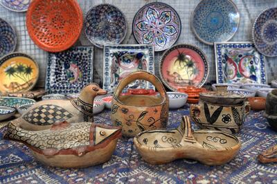 Pottery crafted in Sejnane is displayed at a souvenir shop in the Tunisian capital Tunis on May 10, 2019. The pottery skills of the women of Sejnane have been recognised in 2018 by the UNESCO as an Intangible Cultural Heritage of Humanity. They are known for their practice of using a specific technique to produce terracotta artefacts, sometimes decorated with red and black patterns. / AFP / FETHI BELAID

