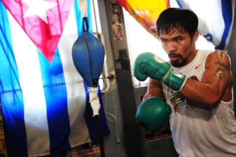 Manny Pacquiao works out at a media day training session at Wildcard Boxing Club in Hollywood, California, October 26, 2011.   Pacquiao will defend his World Boxing Organization (WBO) welterweight title against Juan Manuel Márquez in Las Vegas on November 12.    AFP PHOTO / Robyn Beck