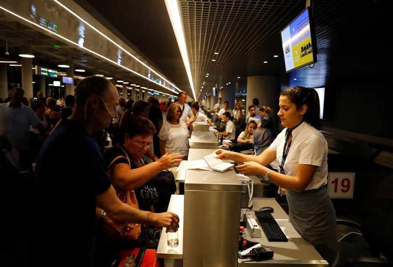 British passengers queue up in a check-in service at Dalaman Airport after Thomas Cook, the world's oldest travel firm, collapsed stranding hundreds of thousands of holidaymakers around the globe and sparking the largest peacetime repatriation effort in British history, in Dalaman, Turkey, September 23, 2019. REUTERS/Umit Bektas