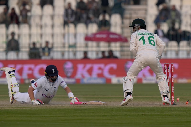 England's Ollie Pope, left is run out by Pakistan' wicketkeeper Muhammad Rizwan for four. AP
