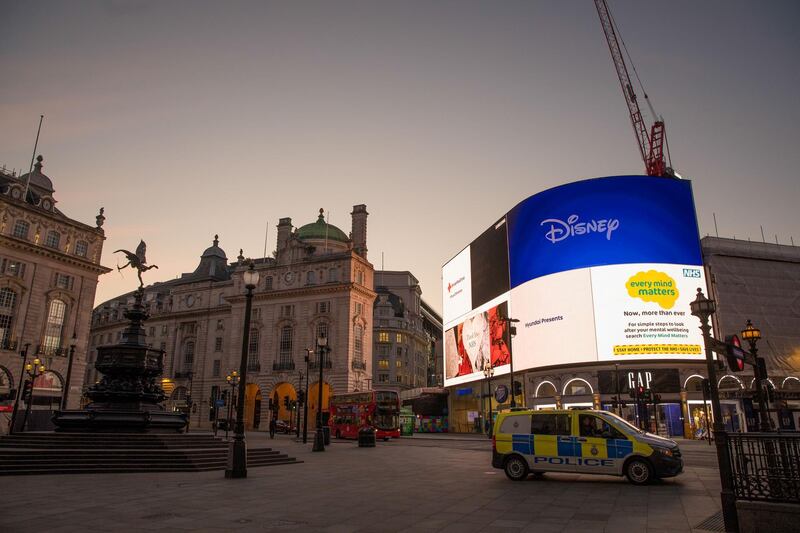 A police van sits parked in view of a large digital advertising screens near the statue of Eros in the Piccadilly Circus district of central London, U.K. on Monday, May 4, 2020. Cabinet Office Minister Michael Gove said the hospitality industry will be the last to see restrictions lifted, as it is the one where it is hardest to maintain social distancing. Photographer: Jason Alden/Bloomberg