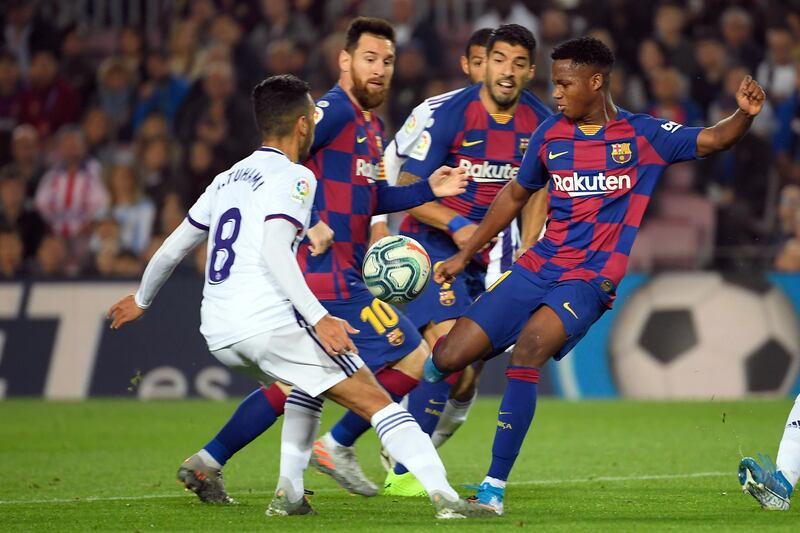 Barcelona's Guinea-Bissau forward Ansu Fati (R) vies with Valladolid's Moroccan midfielder Anuar during the Spanish league football match between FC Barcelona and Real Valladolid FC at the Camp Nou stadium in Barcelona on October 29, 2019. (Photo by LLUIS GENE / AFP)