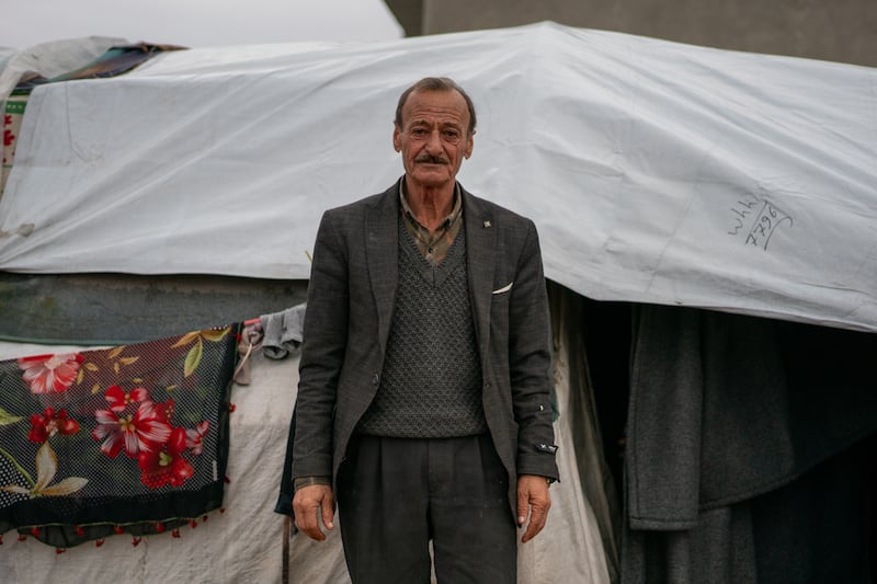 Jindires resident Haidar Sido, 62, in front of the tent where his family now live. He said many people are living in similar circumstances, without receiving any real assistance