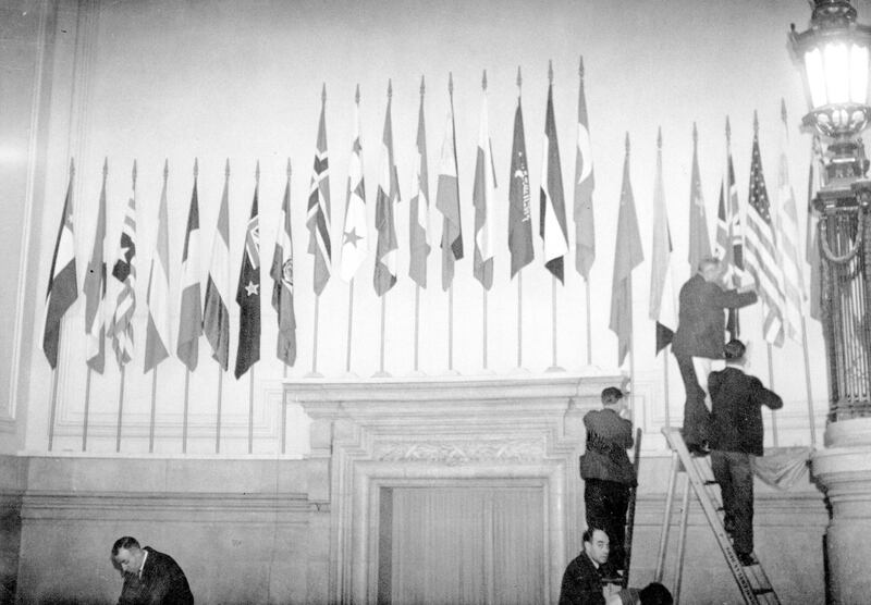 January 1946:  The flags of the United Nations being put up over the main entrance hall in Central Hall.  (Photo by Topical Press Agency/Getty Images)