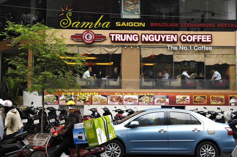 Customers sit inside a Trung Nguyen Coffee outlet in Ho Chi Minh City, Vietnam. Munshi Ahmed / Bloomberg
