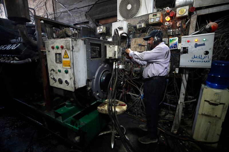 An electrician works on a generator in Iraq's capital Baghdad on July 13. AFP