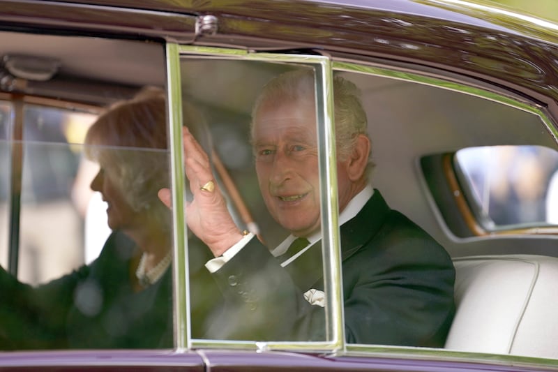King Charles waves as he leaves Clarence House for Westminster Hall. AP