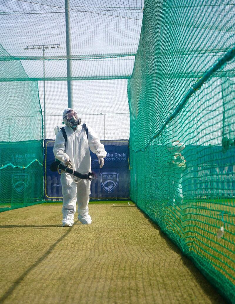 Workers in PPE disinfecting the practice area at Abu Dhabi Cricket in order for Mumbai Indians and Kolkata Knight Riders to train ahead of the IPL. Courtesy Abu Dhabi Cricket