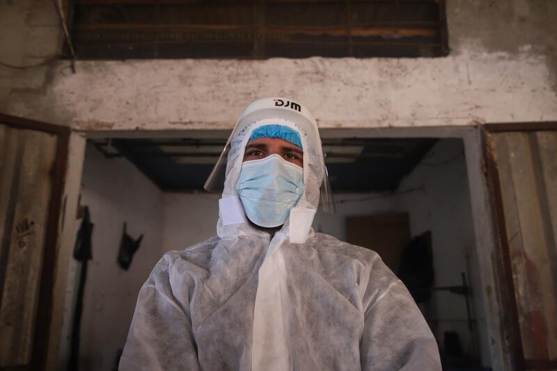 A health worker affiliated to the Palestinian Health Ministry wears full personal protective equipment (PPE) during Covid-19 testing at a market in Khan Yunis, Gaza, on Thursday, Jan. 21, 2020. Israel's vaccine program has raised questions about the country's responsibility toward the 2.7 million West Bank Palestinians living under its occupation, and the 2 million people in the Gaza Strip whose movement and ability to trade it still heavily restricts. Photographer: Ahmad Salem/Bloomberg