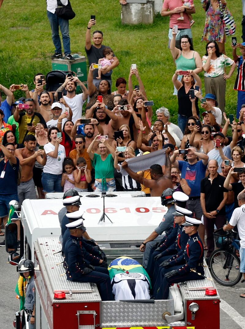 The casket of Brazilian legend Pele is transported by the fire department from his former club Santos' Urbano Caldeira Stadium. Reuters
