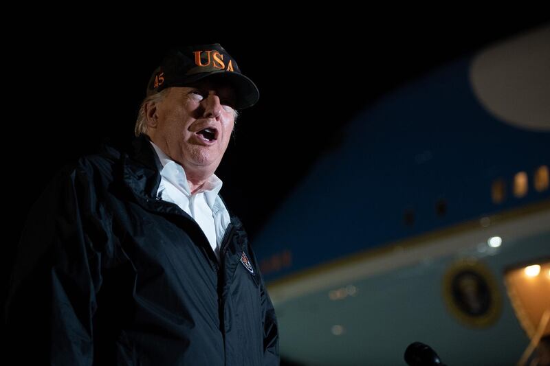 US President Donald Trump speaks to the media prior to boarding Air Force One before departing from Naval Air Station Point Mugu in California, November 17, 2018, as he travels to view wildfire damage. President Donald Trump spent the day in California to meet with officials, victims and the "unbelievably brave" firefighters there, as more than 1,000 people remain listed as missing in the worst-ever wildfire to hit the US state.  / AFP / SAUL LOEB
