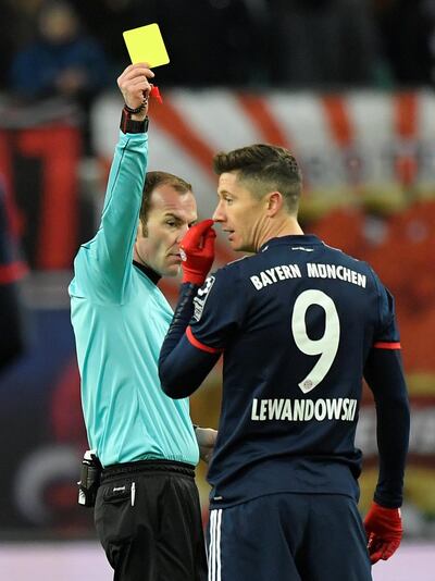 Soccer Football - Bundesliga - RB Leipzig vs Bayern Munich - Red Bull Arena, Leipzig, Germany - March 18, 2018   Bayern Munich's Robert Lewandowski is shown a yellow card by referee Marco Fritz   REUTERS/Matthias Rietschel    DFL RULES TO LIMIT THE ONLINE USAGE DURING MATCH TIME TO 15 PICTURES PER GAME. IMAGE SEQUENCES TO SIMULATE VIDEO IS NOT ALLOWED AT ANY TIME. FOR FURTHER QUERIES PLEASE CONTACT DFL DIRECTLY AT + 49 69 650050