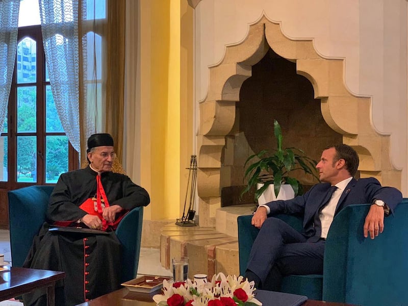 French President Emmanuel Macron meets Lebanese Maronite Patriarch Bechara Rai at the Pine Residence in Beirut. Bkerki Press Office / AFP