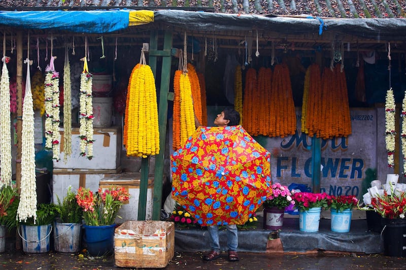 A customer shops for garlands in Gauhati, India. Anupam Nath / AP Photo
