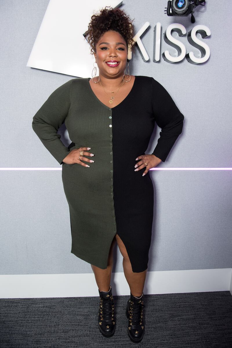 Lizzo in a simple black and green dress in London in 2019. Getty Images