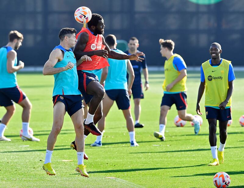 Barcelona's Robert Lewandowski and Franck Kessie during training. AFP