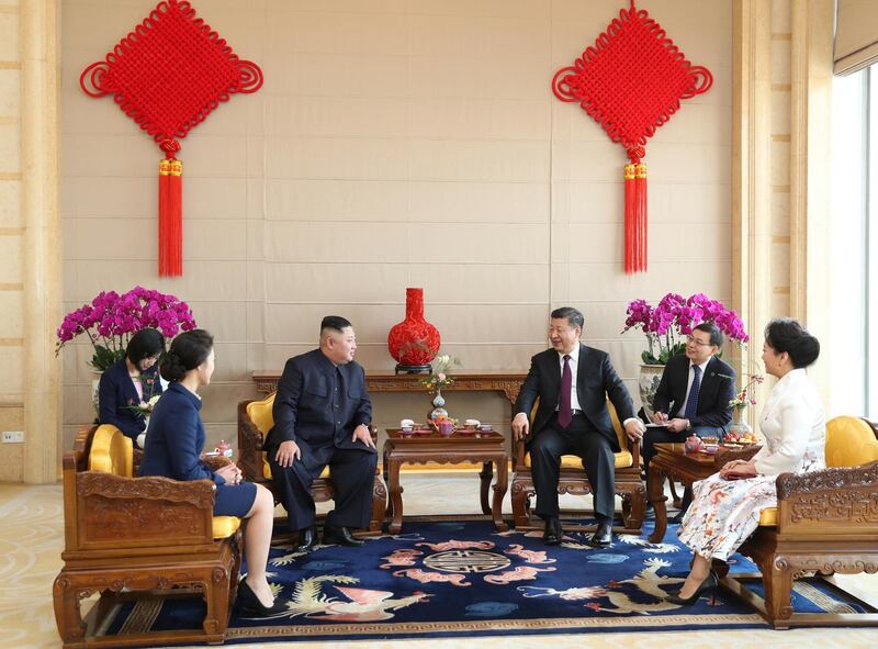 Kim Jong-un, his wife Ri Sol Ju, and Xi Jinping, his wife Peng Liyuan, attend a meeting at the Beijing Hotel. AP Photo