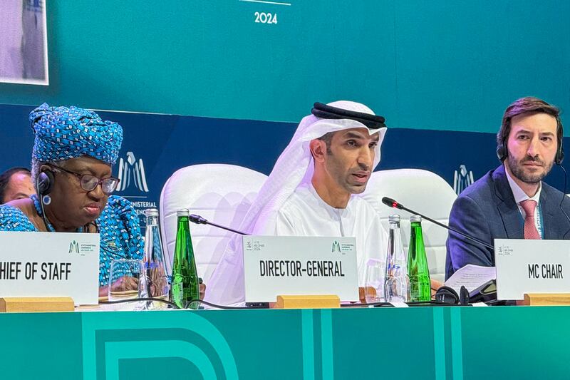 Dr Thani Al Zeyoudi, UAE Minister of State for Foreign Trade, centre, and WTO chief Ngozi Okonjo-Iweala, left, are seen at the trade body's biennial conference in Abu Dhabi. AP