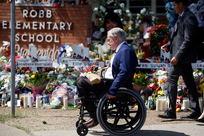 Texas Governor Greg Abbott passes in front of a memorial outside Robb Elementary School to honour the victims killed. AP