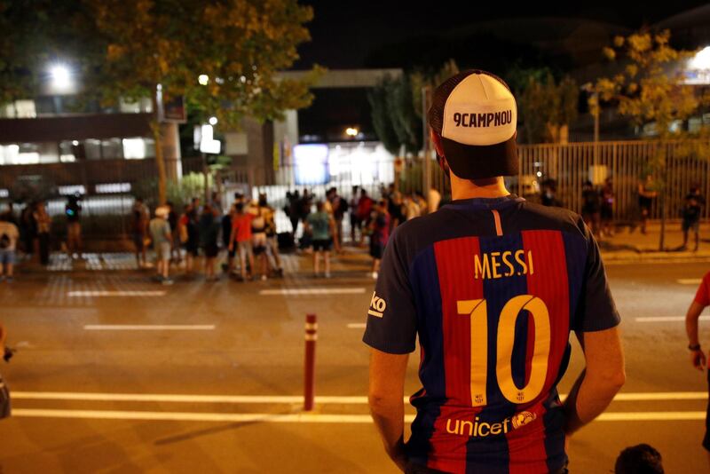 Dozens of FC Barcelona fans gathered outside Camp Nou Stadium.  EPA