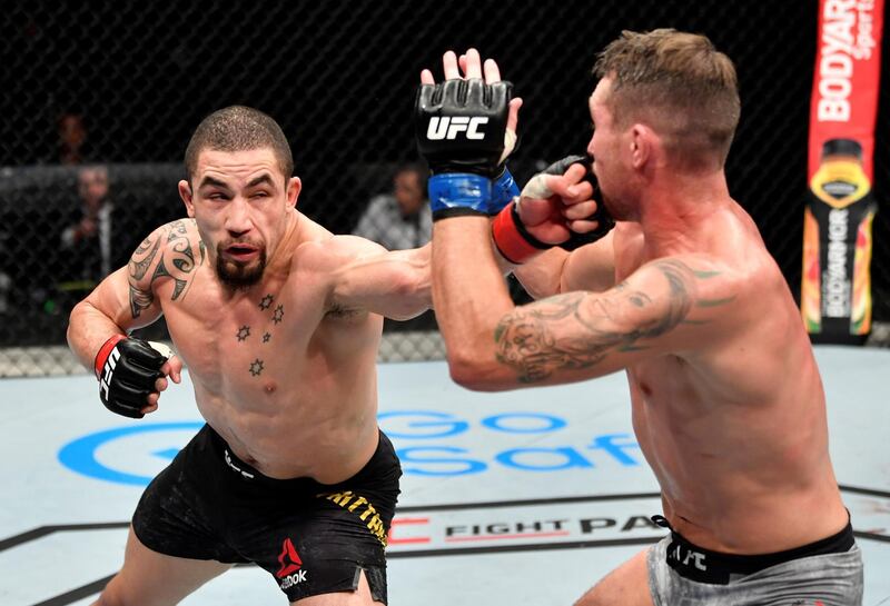 ABU DHABI, UNITED ARAB EMIRATES - JULY 26: (L-R) Robert Whittaker of New Zealand punches Darren Till of England in their middleweight fight during the UFC Fight Night event inside Flash Forum on UFC Fight Island on July 26, 2020 in Yas Island, Abu Dhabi, United Arab Emirates. (Photo by Jeff Bottari/Zuffa LLC via Getty Images)