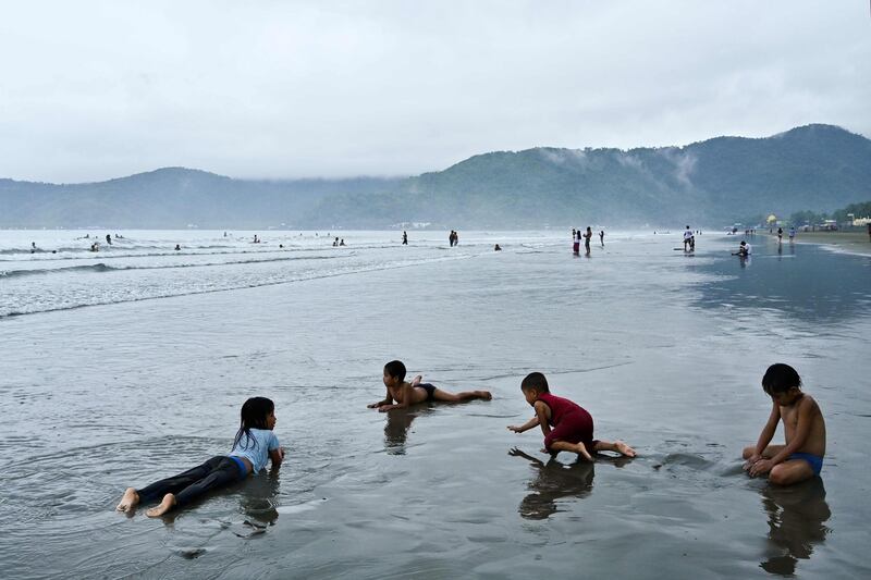 Children play by the shore in the western Philippine coastal town of Baler, Aurora province. AFP