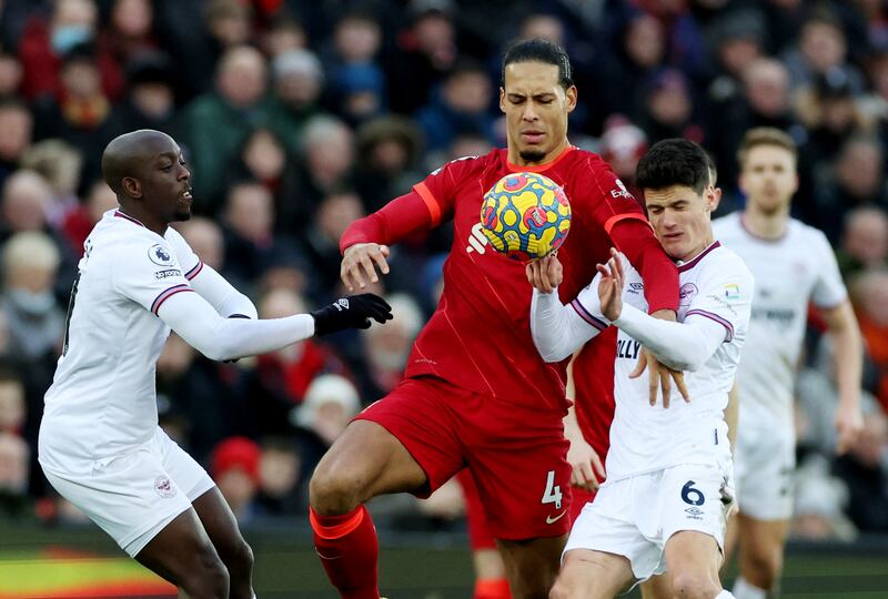 Liverpool defender Virgil van Dijk challenges for the ball against Brentford's Christian Norgaard and Yoane Wissa. Reuters