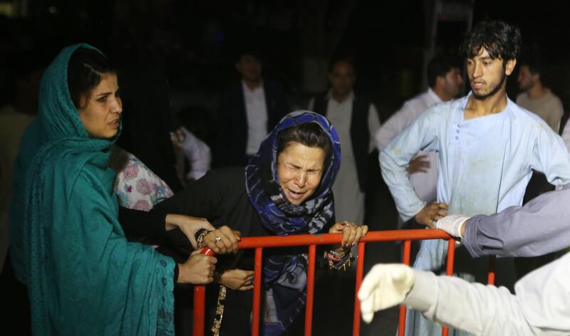 An Afghan woman who has lost his husband and two sons grieves at the door of the hospital, after a suicide attacker detonated his explosive vest among a wedding ceremony in a wedding hall in Kabul. EPA