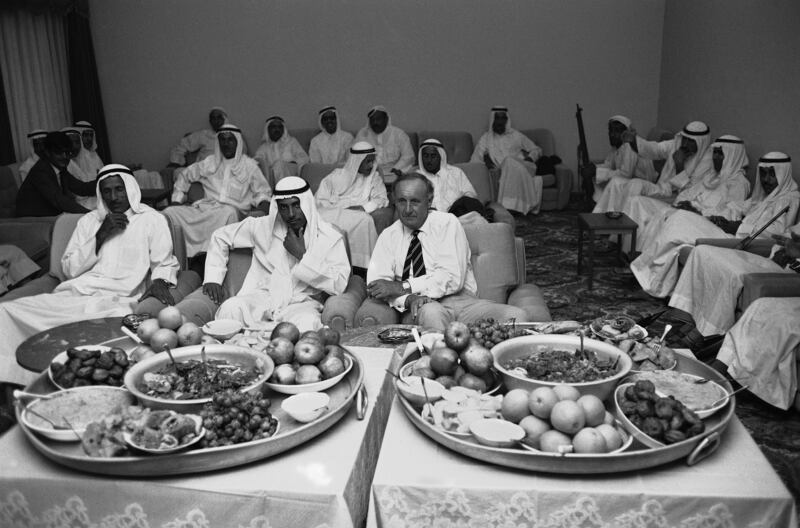 A British official mingles with local dignitaries at a feast in November 1971. AP