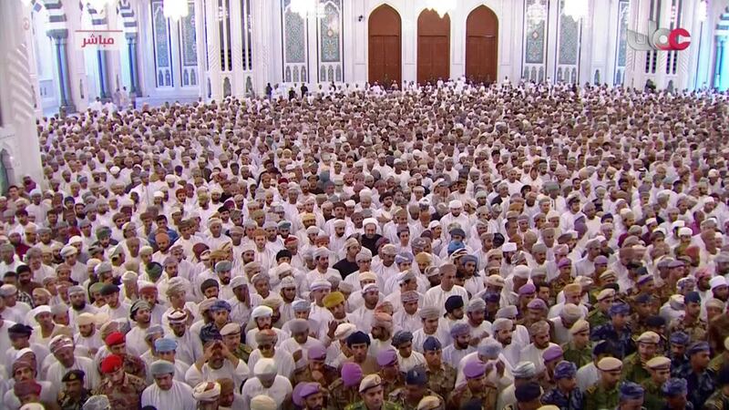 People attend a funeral service for Sultan Qaboos, at the Grand Mosque that bears his name in Muscat. Oman TV via AP