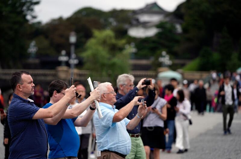 Visitors take pictures at the Imperial Palace outer garden in Tokyo, Japan.  EPA