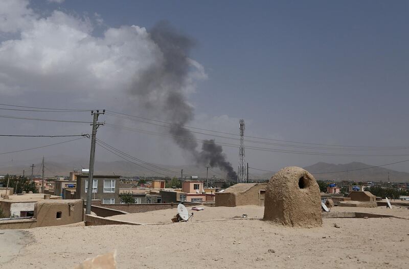 Smoke rising into the air after Taliban militants launched an attack on the Afghan provincial capital of Ghazni on August 10, 2018. - US forces launched airstrikes on August 10 to counter a major Taliban assault on an Afghan provincial capital, where terrified residents cowered in their homes amid explosions and gunfire as security forces fought to beat the insurgents back. (Photo by ZAKERIA HASHIMI / AFP)