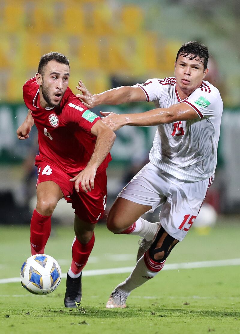 UAE's Fabio de Lima battles with Abbas Assi of Lebanon during their World Cup 2022 qualifier at the Zabeel Stadium in Dubai. Chris Whiteoak / The National