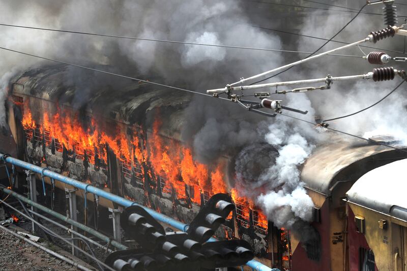 Flames engulf a train at Secunderabad railway station. AP