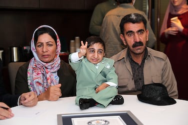 Guinness World Records declared Afshin Ghaderzadeh 20 years old as world’s shortest man with the height of 65.24 cm in Dubai. He is with his parents during the press conference in Dubai. Pawan Singh / The National