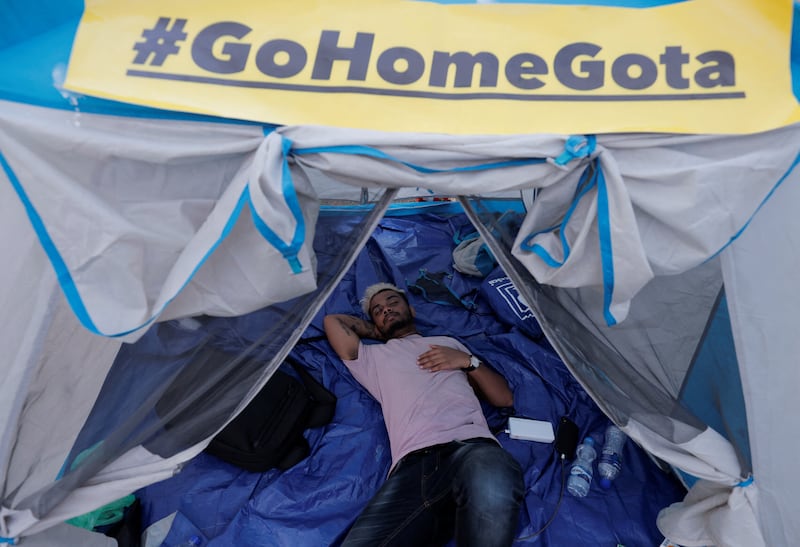A demonstrator at Gota-Go Village in Colombo rests in one of the protest camp's many tents. Reuters