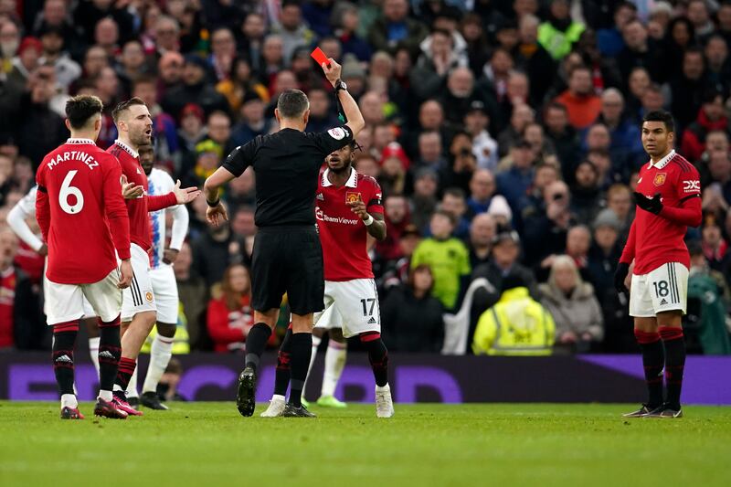 Referee Andre Marriner shows a red card to Manchester United's Casemiro. AP