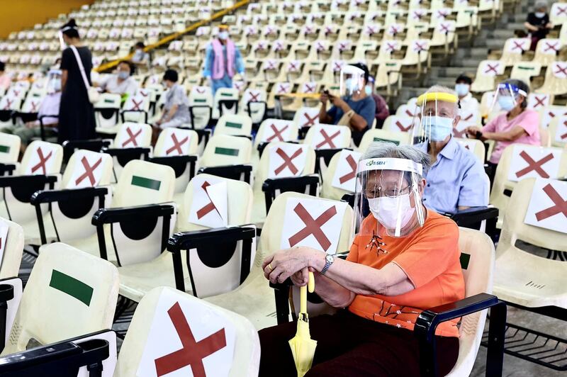 People wait at an observation area after receiving a vaccination dose during an inoculation session for people over 85 years in New Taipei City, Taiwan. Reuters
