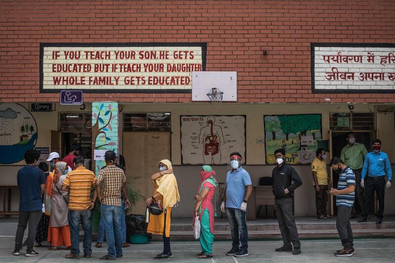 People queue to receive Covid-19 vaccinations in New Delhi. Getty