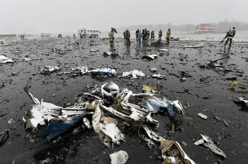 Russian emergency rescuers and forensic investigators work on the wreckage of the flydubai passenger jet which crashed, killing all 62 people on board as it tried to land in bad weather in the city of Rostov-on-Don on March 19, 2016. - The plane, which came from Dubai, was making its second attempt to land when it missed the runway, erupting in a huge fireball as it crashed, leaving debris scattered across a wide area. The ministry said more than 700 rescuers and 100 vehicles were combing the area in driving wind and snow where the wreckage was strewn, with investigators confirming one of the plane's black boxes had been retrieved. (Photo by - / AFP)