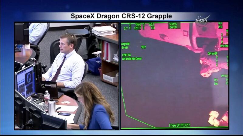 Nasa's ground control in Houston observes the docking. Nasa / YouTube screengrab