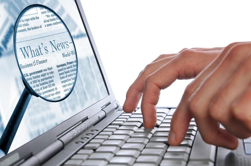 Man's hands are entering some words on the laptop keyboard for the Internet news. Both images you may buy separately here: laptop with hands #7292297 and magnifying glass #7756620