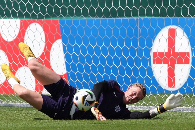 England goalkeeper Jordan Pickford makes a save during training. AFP