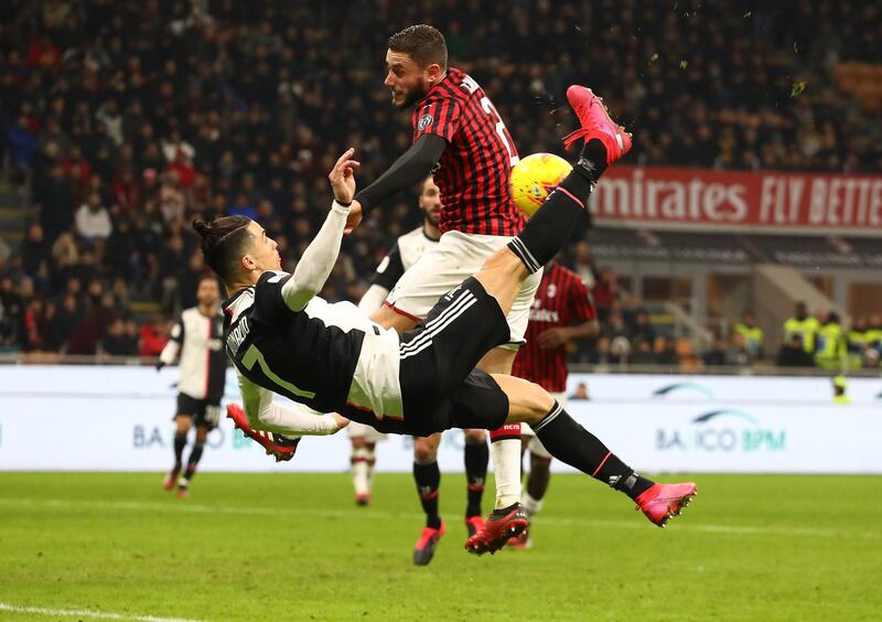 Cristiano Ronaldo's overhead kick strikes the arm of Milan's Davide Calabria to earn Juventus a controversial late penalty at the San Siro on Thursday. Getty