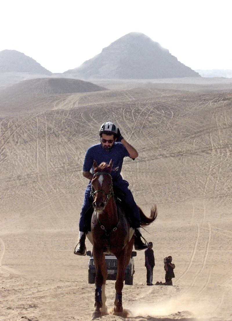 Sheikh Mohammed riding through Egypt's Saqqara desert against a backdrop of pyramids on April 21, 2001.