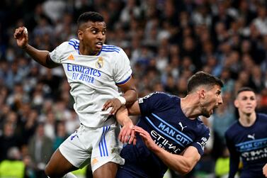 Real Madrid's Brazilian forward Rodrygo scores a goal during the UEFA Champions League semi-final second leg football match between Real Madrid CF and Manchester City at the Santiago Bernabeu stadium in Madrid on May 4, 2022.  (Photo by GABRIEL BOUYS  /  AFP)