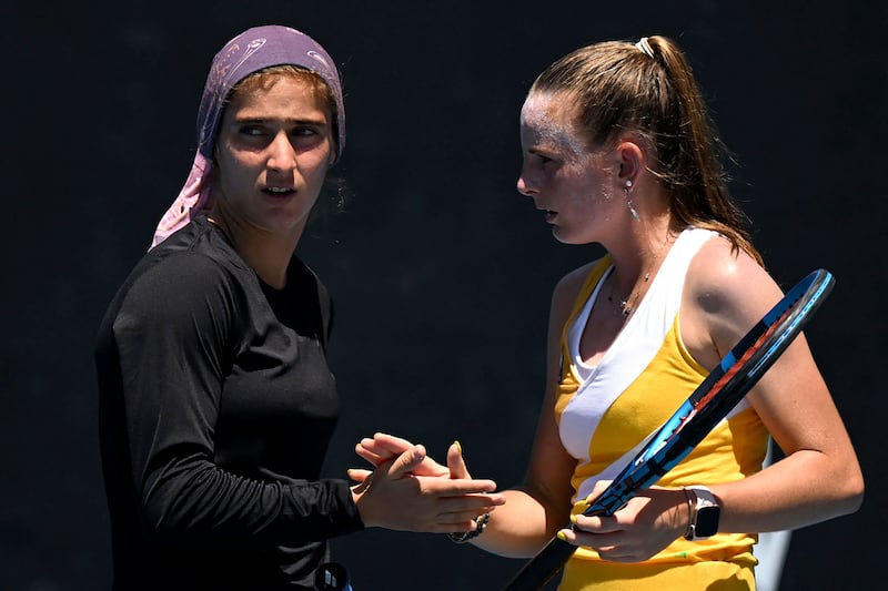 Meshkatolzahra Safi of Iran, left, and Nahia Berecoechea of France compete during a girls doubles match at the Australian Open. AFP